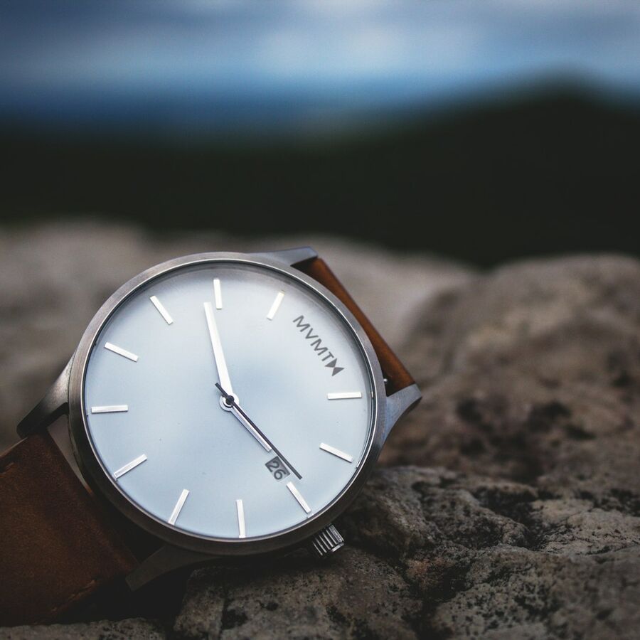 Chronograph resting on river stones